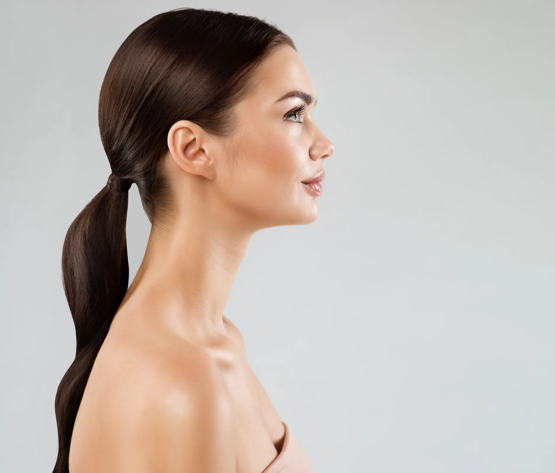 Profile of woman with long ponytail.