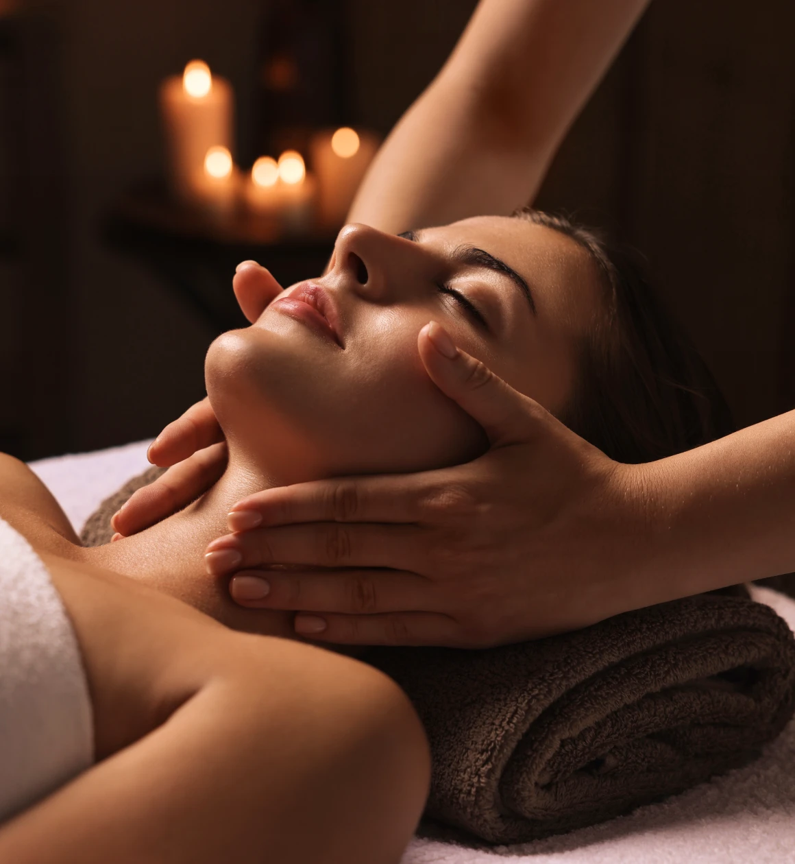 Woman receiving a relaxing facial massage.