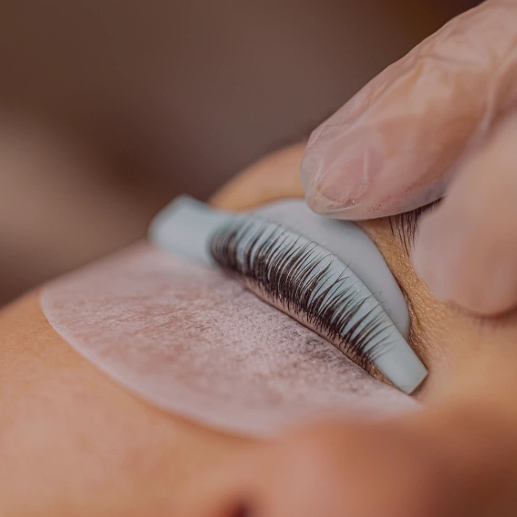 Eyelash extension application close-up view.
